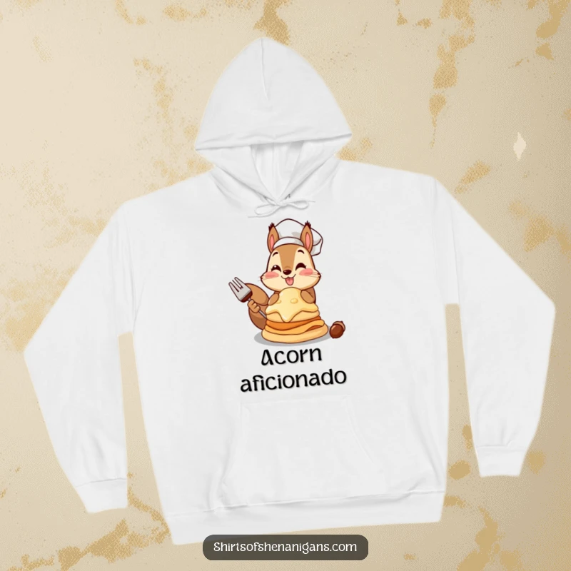 Funny squirrel chef hoodie featuring a squirrel proudly presenting a giant acorn pancake, perfect for cozy chefs.
