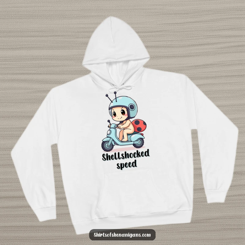 Funny snail hoodie showing a determined snail wearing a tiny helmet, racing a ladybug scooter, offering warmth and motivational humor.