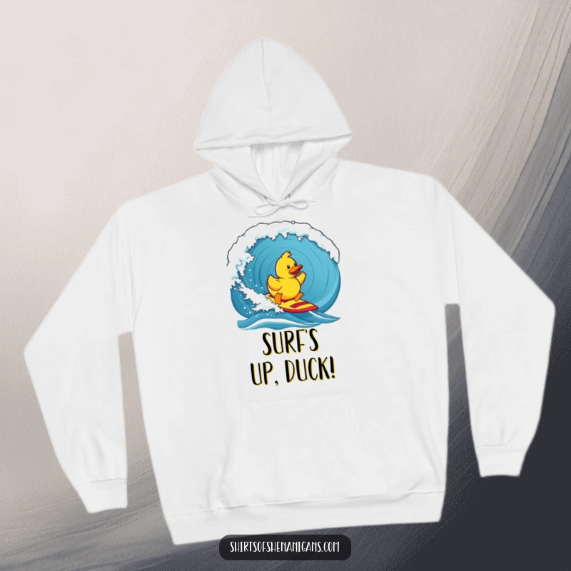 Funny hoodie, a brave rubber duck mastering a giant surf wave, exuding determination and ocean-themed humor.