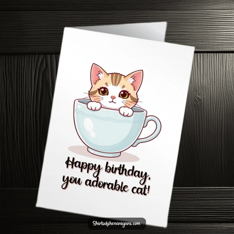 Funny Free Printable Birthday Card: A curious cat peeks mischievously from inside a giant, comfortable teacup.