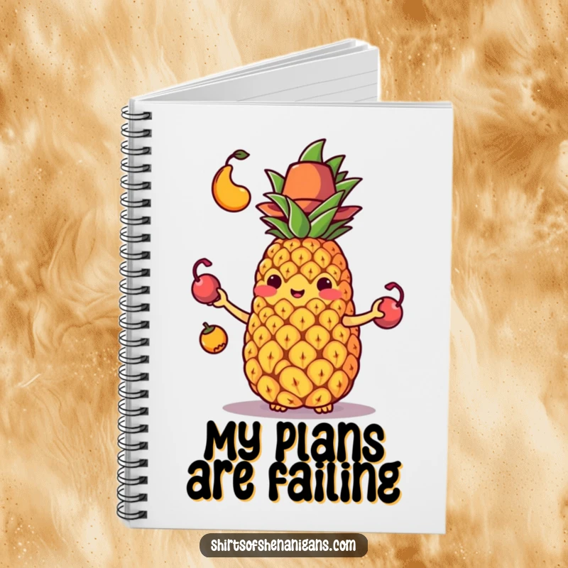 Funny notebook cover with a juggling pineapple in a tiny hat comically dropping its fruit, a humorous design.