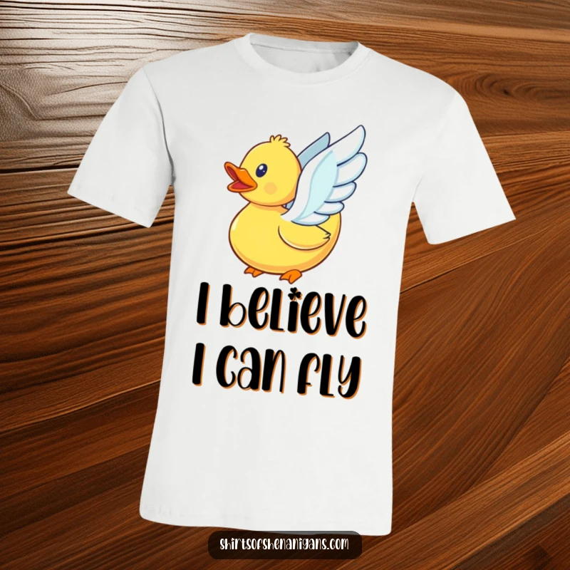 Funny rubber duck with small, flapping wings, attempting to fly with determination on a comfortable t-shirt.