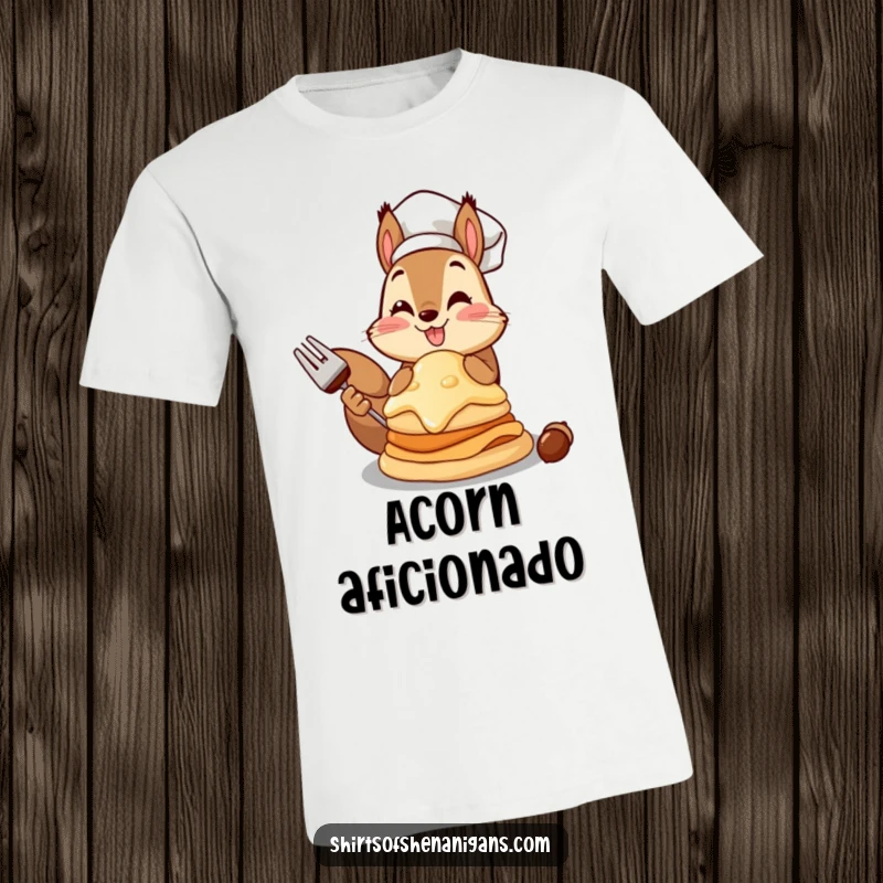 Funny squirrel chef t-shirt depicting a proud squirrel showcasing a massive pancake made from an acorn.