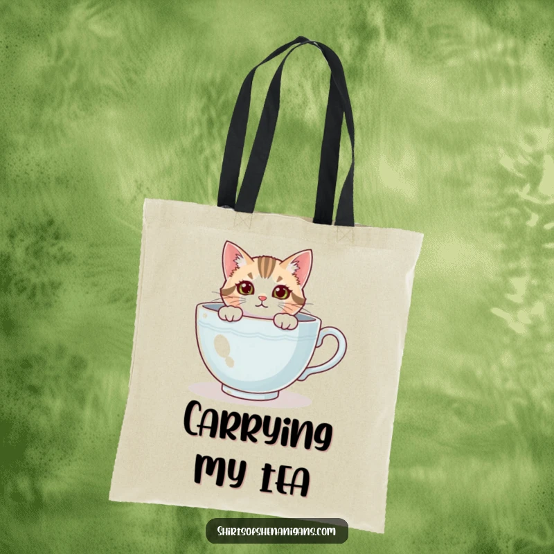 Funny cat tote bag showing a curious feline peeking from a giant teacup, ready for errands. A practical funny gift.