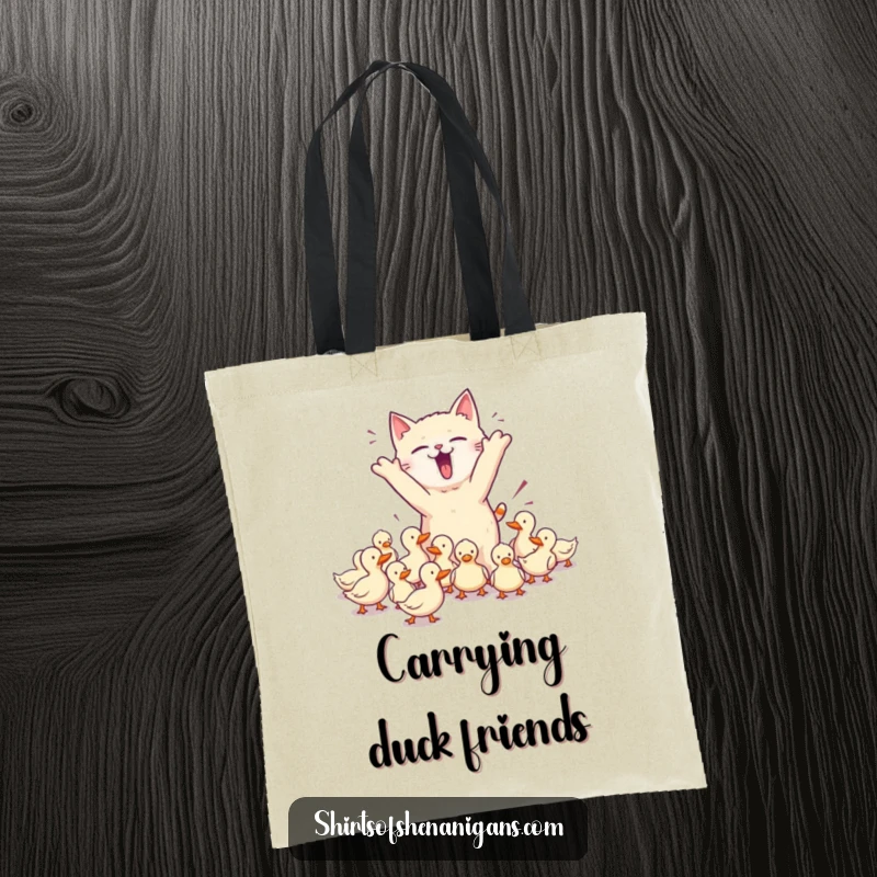 Funny tote bag featuring a chaotic cat herding ducks, ideal for pet owners and a functional, funny gift.